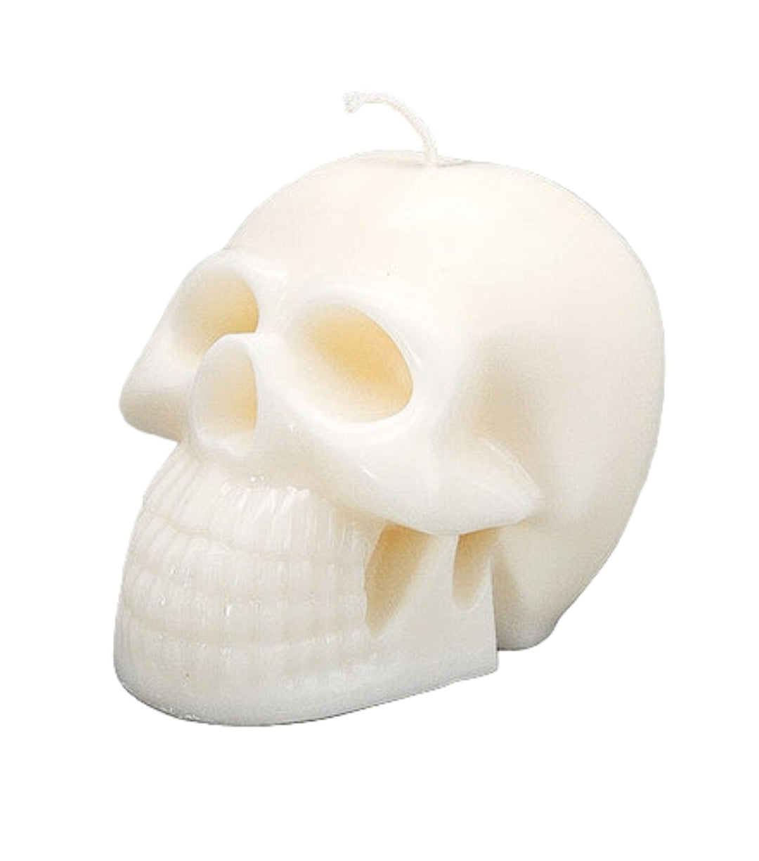 Skull-shaped candle on a gray background