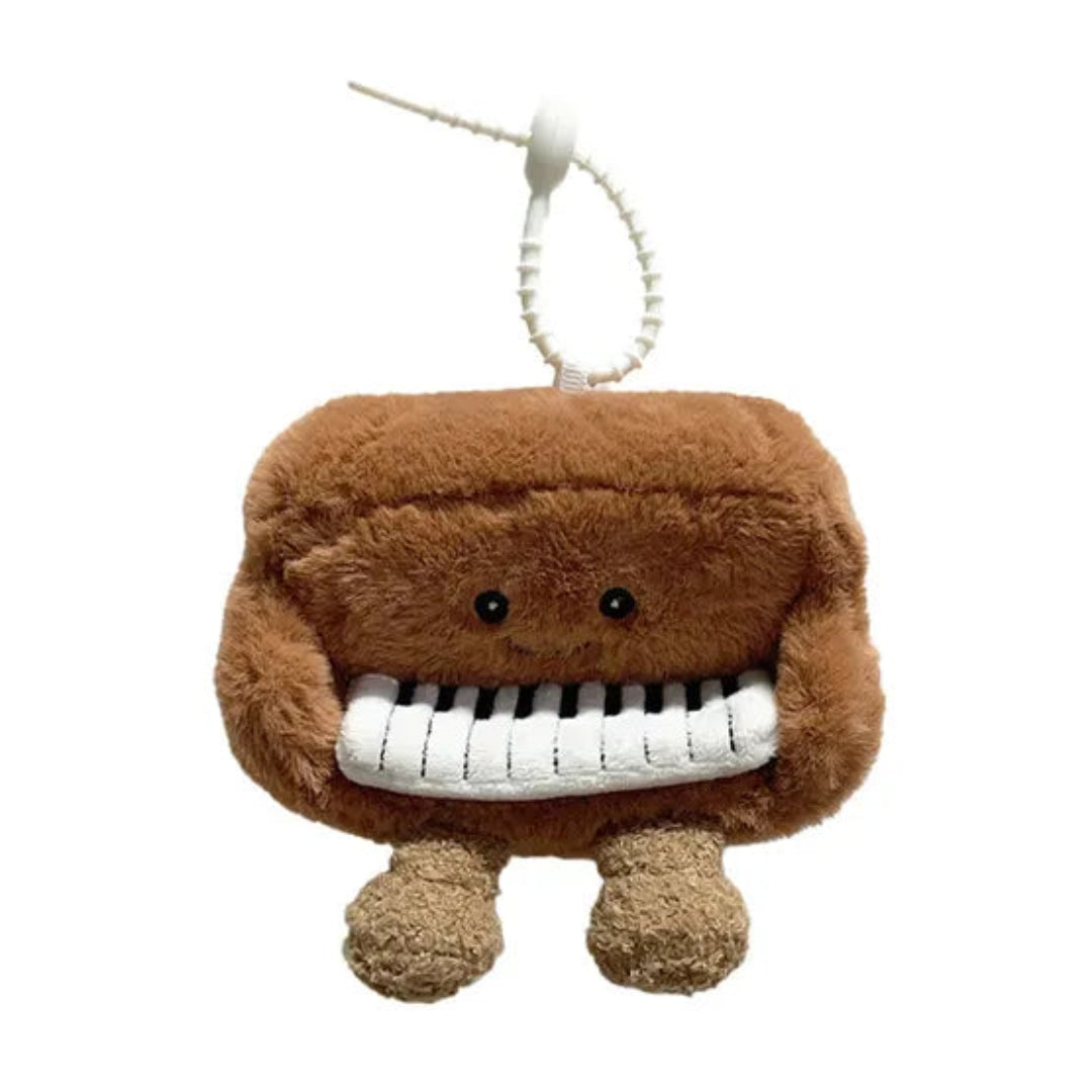 Plush toy piano character on a white background