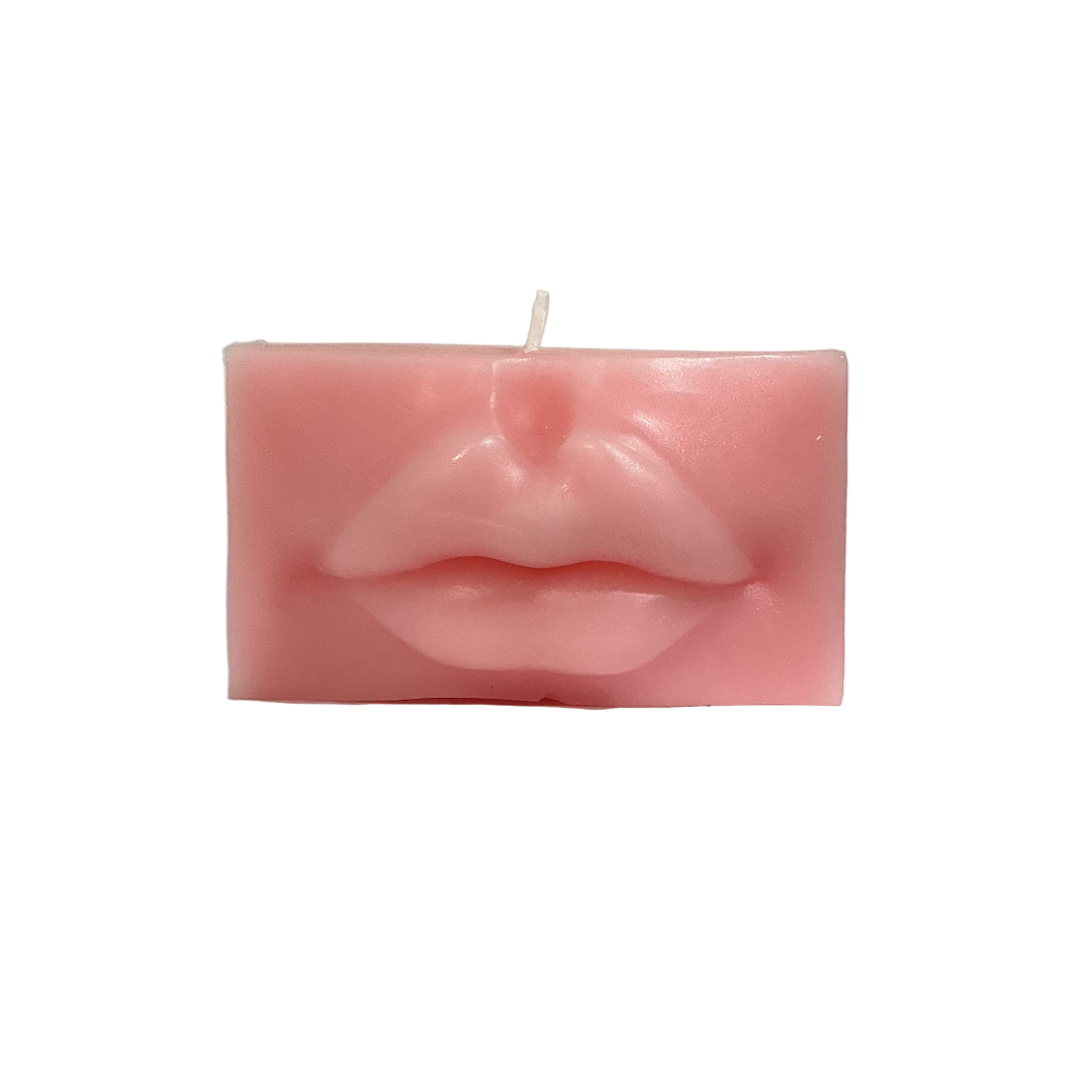 Candle shaped like lips on a gray background