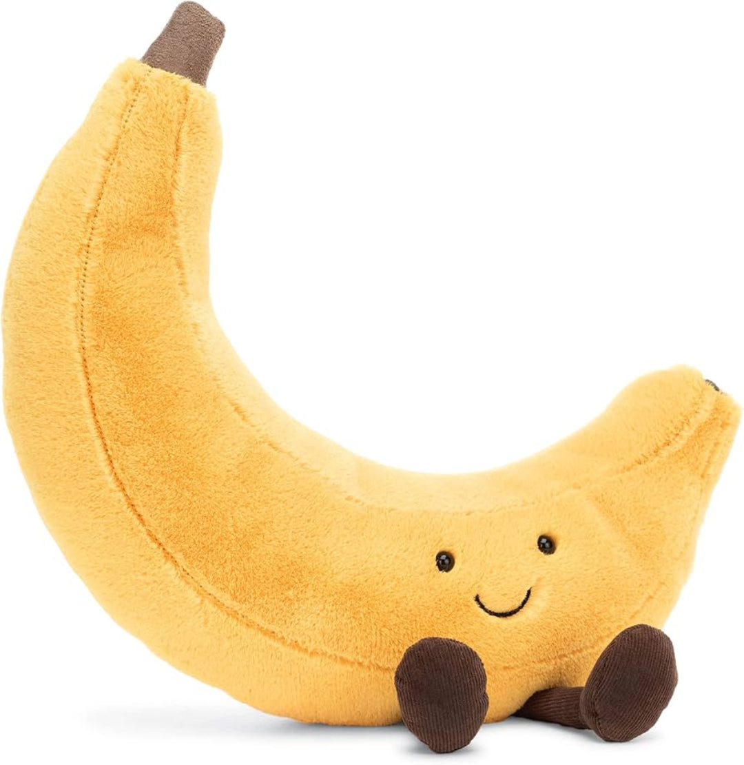 Plush banana toy with a smiling face on a white background